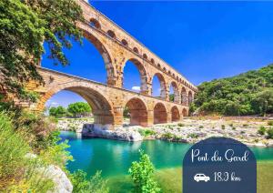 a bridge over a river with green water at NEW! Wifi, Netflix Le Refuge des Berges in Beaucaire
