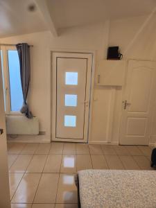 an empty room with a door and a window at Maison studio in Paris +2 photos