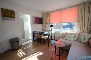 a living room with a couch and a table at Pension Oranje in Zandvoort