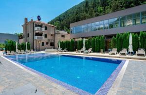 a large swimming pool in front of a building at BELAIR Rooms Montenegro in Sutorina