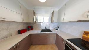 a kitchen with a sink and a counter top at Villa Horizontes 1 in Possidi +12 photos