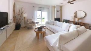 a living room with a white couch and a table at Villa Horizontes 1 in Possidi