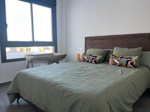 a bedroom with a large bed with pillows and a window at Casa Posterus, villa met prive zwembad in Dolores +45 photos