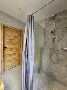 a bathroom with a shower with a shower curtain at Malowany Las in Międzybrodzie Bialskie +31 photos