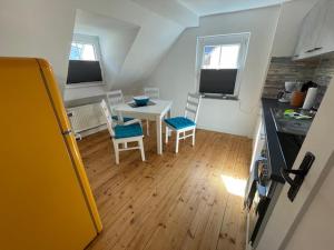 a small kitchen with a table and chairs in a kitchen at Ferienhaus am Fallertor in Alken