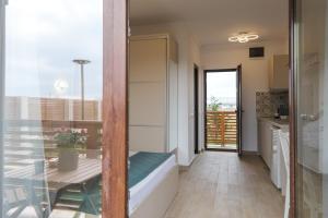 a small kitchen with a table and a dining room at Pensiunea EVIA CORBU in Corbu