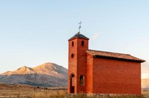 a brick building with a cross on top of it at La Casa de Forja in Tarilonte