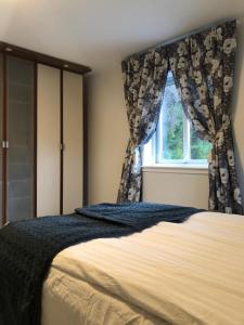 a bedroom with a bed and a window at Landvetter Airport B&B and Parking in Härryda