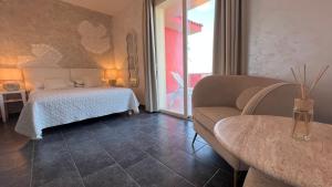 a living room with a bed and a couch at Borgo di Santa Barbara in Santa Domenica