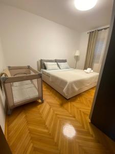a bedroom with a bed and a wooden floor at Apartman Justina Medulin for 2 person in Medulin