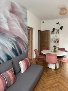 a living room with a couch and a table at Dawna Mleczarnia Apartamenty SOSNOWY in Nowa Ruda