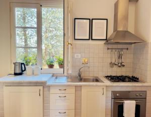 a kitchen with a sink and a stove at Podere Gattabigia in Lastra a Signa