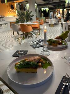 a plate of food on a table with a candle at Lagunowe Zacisze in Zarzecze +17 photos