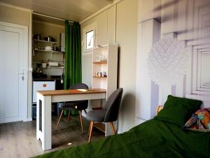 a bedroom with a bed and a desk and a table at Od svitanja do sumraka in Golubac