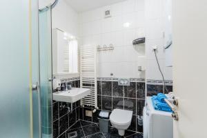 a bathroom with a toilet and a sink at Flex SelfCheckIns 147 - Zagreb - Bedroom - Garage - Loggia in Zagreb