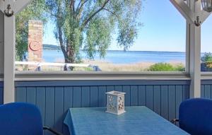 a table with blue chairs and a view of the water at Ferienhaus Kummerow in Kummerow