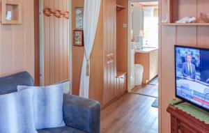 a living room with a couch and a tv at Ferienhaus Kummerow in Kummerow