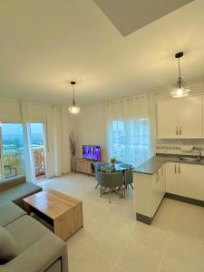 a kitchen and living room with a couch and a table at Newly renovated apartment in Garrucha