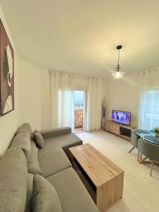 a living room with a couch and a table at Newly renovated apartment in Garrucha