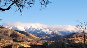 a mountain covered in snow and clouds in the sky at Alpaca Rustic Ranch-peaceful & breathtaking views in Santa Clarita
