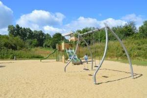 a group of playground equipment in the sand at Appartement bord de mer in Villers-sur-Mer