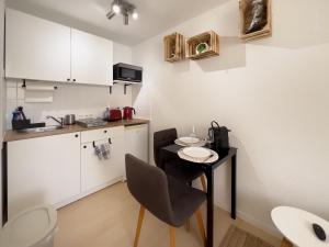 a small kitchen with a small table in a room at Cozy Studi Apartment II - Kaiserslautern in Kaiserslautern