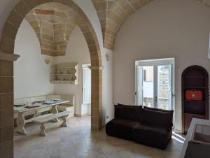 a living room with a table and a couch at Dimora Matteotti in Nardò