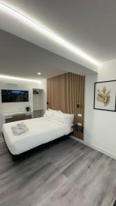 a bedroom with a large white bed in a room at JACUZZI ROOMS PUENTE De VALLECAS in Madrid +39 photos