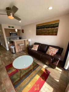 a living room with a couch and a table at The Galveston Victorian Condo in Galveston