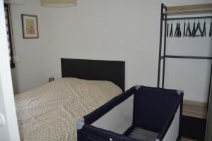 a bedroom with a bed with a black bed frame at Appartement bord de mer in Villers-sur-Mer