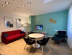 a living room with a red couch and a table at Residence Il Melograno in Sirmione