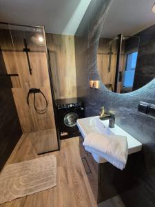 a bathroom with a sink and a shower at Apartamenty Gajewscy in Lipnica Górna