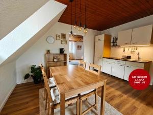 a kitchen and dining room with a wooden table and chairs at Ferienwohnungen Meier in Ebensee