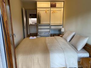 a bedroom with a large white bed in a room at Appartement Crans-Montana in Crans-Montana