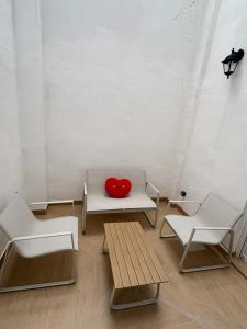 a red heart sitting on a bench in a room at Centric Loft near Arts & Science in Valencia