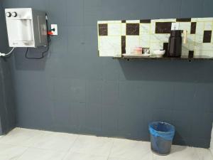 a bathroom with a blue wall with a trash can at NORTE HOTEL Guaraciaba in Guaraciaba do Norte