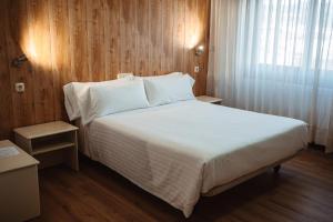 Vuode tai vuoteita majoituspaikassa Hotel Scala