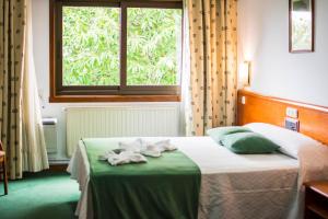 Vuode tai vuoteita majoituspaikassa Hotel Scala