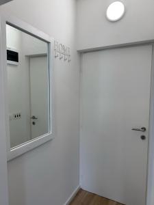 a mirror on the wall next to a door at Michael's in Zadar