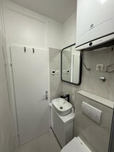 a bathroom with a toilet and a sink and a mirror at Michael's in Zadar
