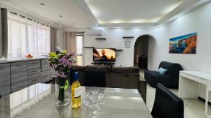 a living room with a couch and a table with wine glasses at Sunny Apartment Gzira in Il-Gżira