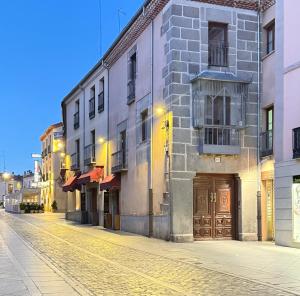 an empty street in a city with buildings at Mirador del cielo in Avila