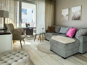 a living room with a couch and a chair at Ferien am Möhnesee - Cozy Home in Möhnesee