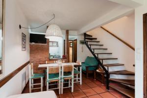 a kitchen and dining room with a staircase and a table and chairs at Miraverde in Pinamar