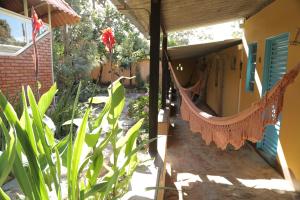 a hammock hanging from a porch of a house at Pousada Beija-Flor in Alto Paraíso de Goiás