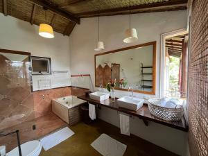 a bathroom with two sinks and a large mirror at Beira Mar Ilha Guest in Ilhabela +227 photos