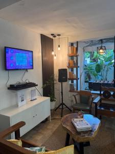 a living room with a tv on a wall at E-Place Resort in Magallanes