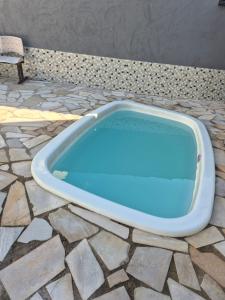 a large blue tub sitting on a stone floor at HOTEL DIVINO PAI ETERNO 2 in Aparecida