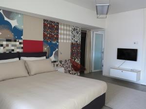 a bedroom with a bed and a tv on a wall at Residence "I Centralissimi Mamiblu' " in Vasto