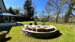 dos sillas y una hoguera en un patio en Acorn Lodge, 4 bedroom, Glasbury, Hay & Brecon, en Glasbury